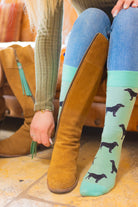 Adorable black Labrador socks set against a lovely light mint green background, designed for dog lovers and fans of countryside fashion. These cozy socks feature playful Labrador motifs, making them a perfect accessory for any casual outfit. Ideal for those who appreciate a touch of whimsy and comfort, these socks celebrate the bond between dogs and their owners while enhancing your country-inspired wardrobe