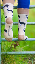 "These charming collie dog farm socks feature a black and white collie design on a light brown background, accented by rich brown heel and toe. Perfect for completing a country outfit, they add rustic flair and comfort for long walks in the countryside. Embrace your love for rural life and your furry friends with these stylish and cozy socks!"
