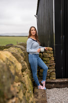 Girl standing wearing pink cow ankle socks 