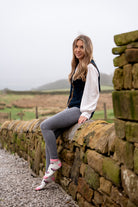 country girl say on stone wall wearing pink 4x4 ankle socks 