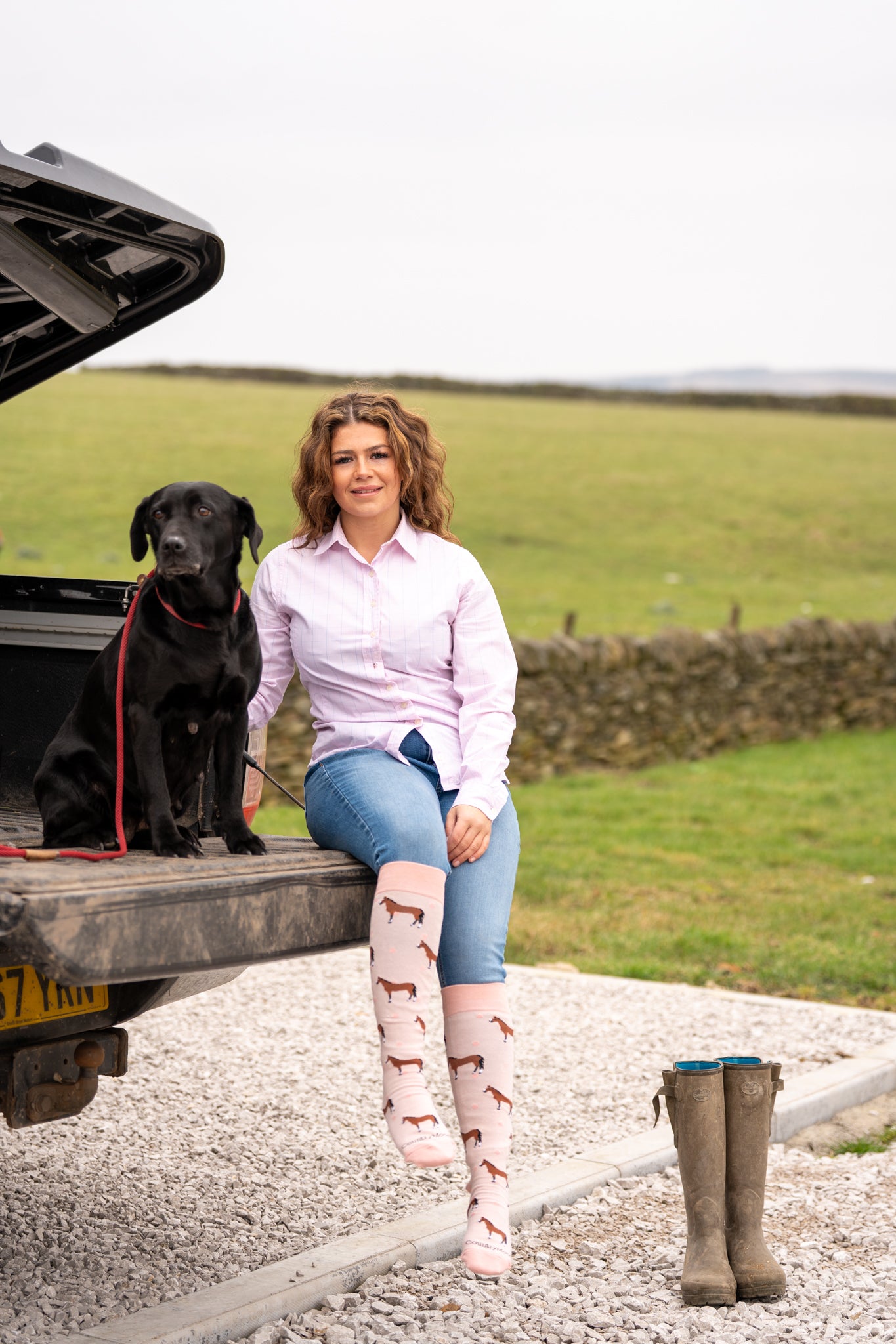 country girl wearing pink horse welly socks 