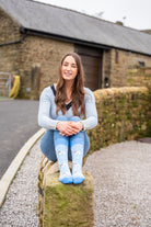 model is wearing blue themed jacob sheep socks 