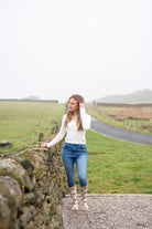 model stood near wall wearing friesian cow welly socks